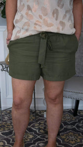 Forever Fierce Front Tie Waist, Linen Paperbag Shorts - Olive - Fate & Co. These super cute front tie waist, linen paper bag shorts are so IN right now!! Featuring an elastic stretch waistband, tie belt and side pockets, these paperboy shorts can be dressed up or worn casually depending on the occasion! Tuck in a more fitted top and wedges for a more "going out" look or front tuck a tee and slide on a pair of flip flops for a more casual day look! 