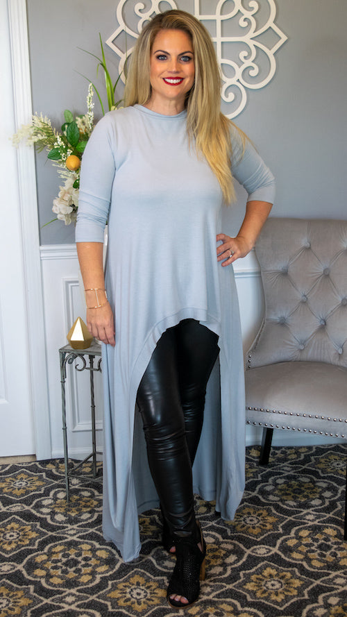 This statement top is stunning ! Featuring a beautiful floor length high-low hemline , 3/4 length sleeve and round neckline, this top is made from a super soft, smooth and stretchy premium fabric that screams look at me...and look at me now! Available in two color choices, Light Grey and Light Olive. We love this top paired with our Feeling Foxy or Feeling Fierce faux leather leggings and heels for a look that will never be forgotten! 