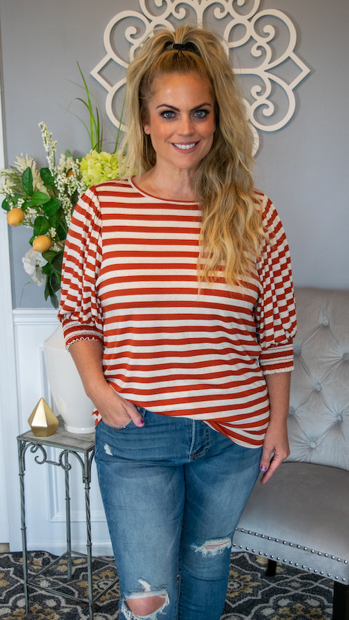 Pass me the pumpkin spice and lets head to the orchard! This jersey knit blouse is anything but basic! Featuring a rust and cream striped pattern , you'll love this 3/4 sleeve blouse for any occasion! This top also has a round neckline, smocked cuff on the sleeves and is the perfect comfortable fit. The lightweight material makes this blouse so comfy and easy to wear all day long! Pair this top with jeans and a pair of boots for a casual chic look! 