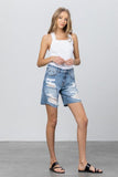 Insane Gene Distressed Premium Bermuda Short 5/28 - Fate & Co. Classic comfort with some funk and flare! Bermuda shorts are all the rage this season and these ultra distressed denim Bermudas are the perfect throw on and go afternoon shorts! These mid rise Bermudas feature a relaxed fit, medium wash and ultra distressed front, we love them paired with a classic white tee or tank and flip flops for a casual summer look.   100% Cotton  Color: Medium Wash