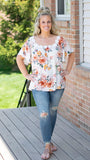 Close to Me Floral Print Blouse w/Flower Trim Detail Top - Fate & Co. This floral print blouse is a must have for summer nights! Featuring a detailed floral trim neckline that can be worn on or off the shoulder, short bell sleeve and stunning bright floral pattern, this top is sure to turn heads. We love this blouse paired with dark wash denim jeans and neutral wedges.   100% Cotton  Color: White with Floral Pattern