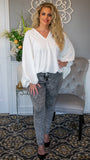 We love our oversized draped dolman sleeve blouse for its effortless style! Featuring a v-neckline , oversized and exaggerated sleeves, elasticize cuffs and elasticize/noises hem.  This blouse offers a billowy silhouette with chic and trendy flair, along with a blank textured canvas to layer necklaces, cardigans and to pair with skirts or denim.  Made in USA 