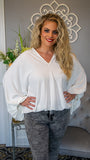 We love our oversized draped dolman sleeve blouse for its effortless style! Featuring a v-neckline , oversized and exaggerated sleeves, elasticize cuffs and elasticize/noises hem.  This blouse offers a billowy silhouette with chic and trendy flair, along with a blank textured canvas to layer necklaces, cardigans and to pair with skirts or denim.  Made in USA 