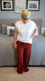 Who doesn't love a great pair of cozy pants? Featuring a super soft texture, loose fit and drawstring waist, these beauties are bound to make a solid rotation in your home. Throw these on with your favorite hoodie and slippers and enjoy a comfy night in!  Bonus... they are also cute enough to wear out and about if needed ;)  Color: Brick Red